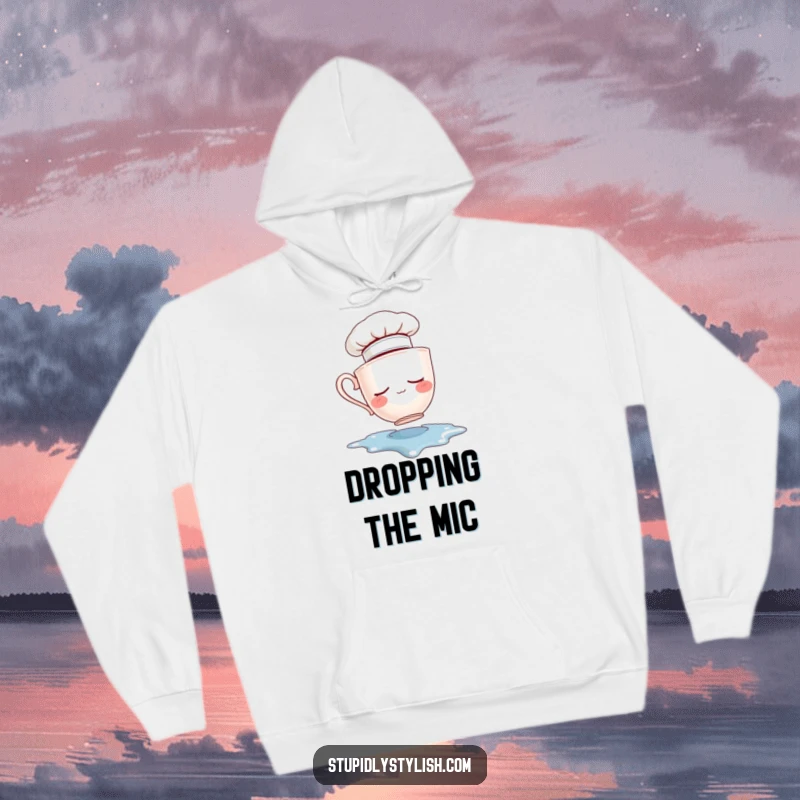 Funny hoodie depicting a sleepy teacup with a chef hat, tumbling into a liquid spill. Cozy and comical wear.