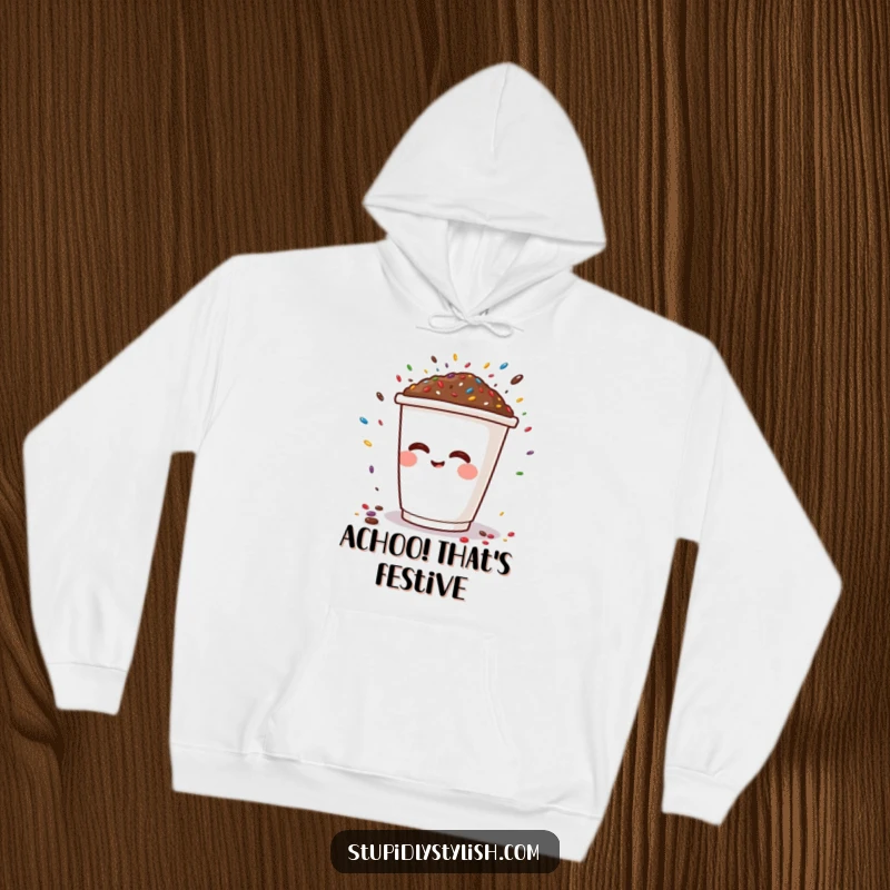 Funny hoodie showcasing a happy coffee cup character sneezing a delightful shower of sprinkles, embodying pure, whimsical humor.