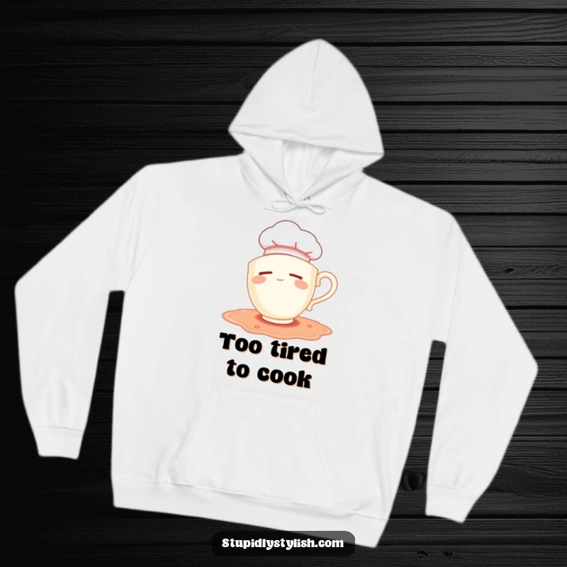 Funny hoodie: sleepy teacup with chef hat falling into a spilled puddle, soft and humorous apparel.