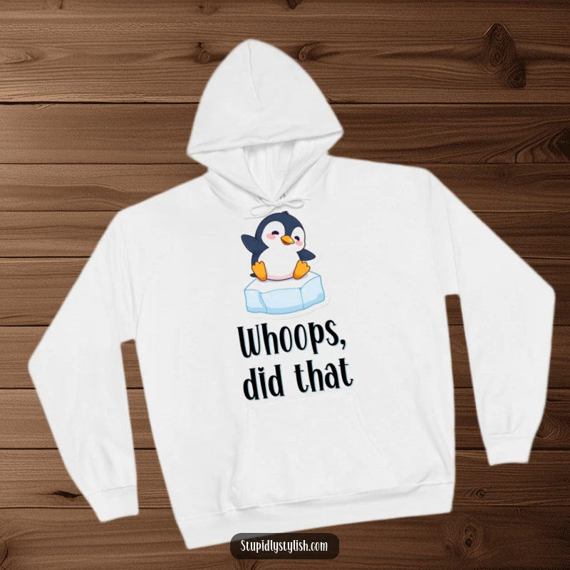 Funny hoodie depicting a clumsy penguin comically losing its footing on a slippery ice cube, bringing humor.
