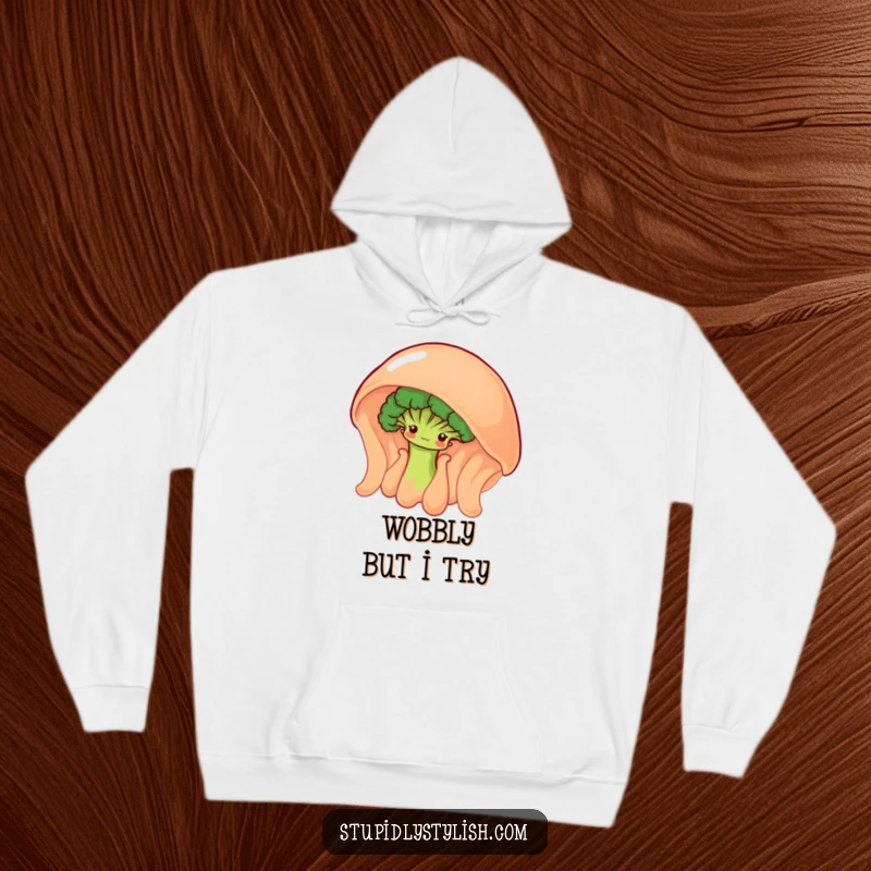 Funny hoodie with a shy broccoli floret peeking from behind a giant, wobbly jelly, offering cozy charm.