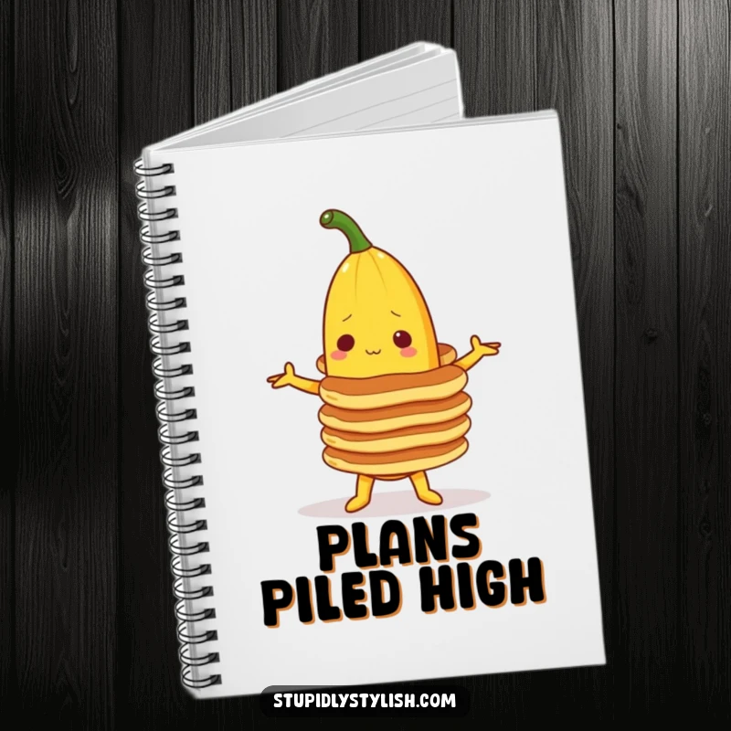Funny notebook cover featuring a banana character trying to balance a stack of pancakes, encouraging creative note-taking and story ideas.
