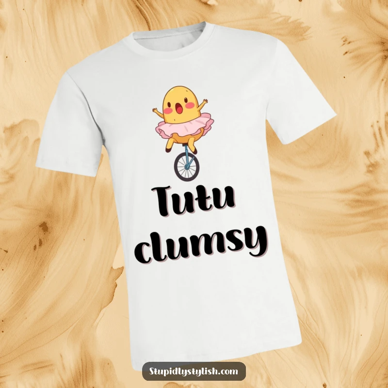 Funny t-shirt graphic of a surprised potato in a ballet tutu hilariously falling off a unicycle.