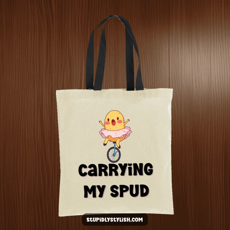 Funny tote bag depicting a surprised potato in a ballet tutu comically falling off a unicycle.