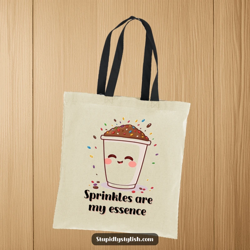 Funny tote bag with a cheerful coffee cup character sneezing a colorful burst of sprinkles, showcasing playful and humorous art.